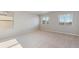 Spacious bedroom with large windows and neutral carpeting at 48260 Shetland Dr, Bennett, CO 80102