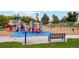 Colorful playground featuring climbing structures, slides, and swings, all set on a safe, soft surface at 48260 Shetland Dr, Bennett, CO 80102