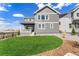 Well-maintained backyard featuring a green lawn and the home's exterior with a covered porch at 3444 Recess Pt, Castle Rock, CO 80108