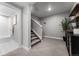 Open finished basement with carpeted floors, modern lighting, and adjacent bathroom with tiled shower at 3444 Recess Pt, Castle Rock, CO 80108