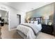 Cozy bedroom features an inviting bed, patterned accent wall, and modern decorative touches at 3444 Recess Pt, Castle Rock, CO 80108