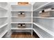 Walk in Pantry with white shelving, complete with decorative storage baskets at 3444 Recess Pt, Castle Rock, CO 80108