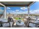 Inviting porch seating area with scenic views of the countryside and open sky at 3444 Recess Pt, Castle Rock, CO 80108
