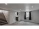 Basement with stairs and window offers lots of space and natural light at 3360 Magnolia St, Denver, CO 80207