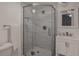Modern bathroom with sleek glass shower, white vanity, and marble-style shower tiles at 3360 Magnolia St, Denver, CO 80207