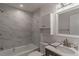 Bathroom with white marble tiling in shower, white vanity with new fixtures, and new lighting at 3360 Magnolia St, Denver, CO 80207