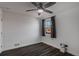 Bedroom featuring hardwood flooring, white walls, a ceiling fan, and a window at 3360 Magnolia St, Denver, CO 80207