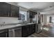 The kitchen features gray countertops, dark cabinets, stainless steel appliances and hardwood flooring at 3360 Magnolia St, Denver, CO 80207