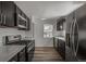 The kitchen features gray countertops, dark cabinets, and stainless steel appliances including a gas range at 3360 Magnolia St, Denver, CO 80207