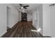 A spacious living room featuring a fireplace and hardwood flooring, a ceiling fan, and an exterior door at 3360 Magnolia St, Denver, CO 80207