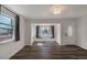 Living room with hardwood flooring, a large window, and a white front door at 3360 Magnolia St, Denver, CO 80207