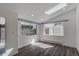 A bright sunroom with multiple windows and a skylight providing ample natural light and hardwood floors at 3360 Magnolia St, Denver, CO 80207