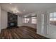 A spacious living room featuring recessed lighting, a black marbled fireplace, and hardwood flooring at 3360 Magnolia St, Denver, CO 80207