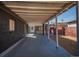 Open patio area with a concrete floor, exposed beams, and access to the backyard at 3360 Magnolia St, Denver, CO 80207