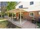 Covered patio with seating area and brick grill at 6618 S Newland Cir, Littleton, CO 80123