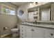 Elegant bathroom with granite countertop and white cabinets at 6618 S Newland Cir, Littleton, CO 80123