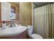 Clean bathroom with single sink vanity, toilet and shower at 6618 S Newland Cir, Littleton, CO 80123