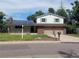 Brick ranch home with solar panels, two-car garage, and landscaped yard at 6618 S Newland Cir, Littleton, CO 80123