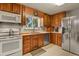 Kitchen with stainless steel appliances and wood cabinets at 6618 S Newland Cir, Littleton, CO 80123