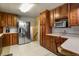 Kitchen with stainless steel appliances and wood cabinets at 6618 S Newland Cir, Littleton, CO 80123