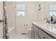 Bathroom featuring sink with modern hardware, tub and shower combo, and an easy to clean toilet at 4138 N Quatar Ct, Aurora, CO 80019