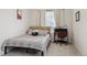 Cozy bedroom with a full bed, desk, neutral carpet, and a window that brings in plenty of natural light at 4138 N Quatar Ct, Aurora, CO 80019