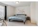 Bright bedroom featuring a queen-size bed, neutral carpet, and a window that brings in plenty of natural light at 4138 N Quatar Ct, Aurora, CO 80019