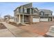 Charming two-story home with a stone facade, covered porch, and two-car garage, showcasing curb appeal and modern design at 4138 N Quatar Ct, Aurora, CO 80019