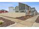 A modern home with neutral siding and a wood fence, surrounded by rock landscaping, offering privacy and style at 4138 N Quatar Ct, Aurora, CO 80019