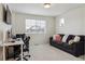 Home office featuring neutral carpet, a large sofa, a desk with two monitors and natural lighting at 4138 N Quatar Ct, Aurora, CO 80019
