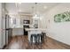 Bright kitchen showcasing an island with bar stools, stainless steel appliances, and white countertops, creating a modern feel at 4138 N Quatar Ct, Aurora, CO 80019