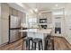 Well-lit kitchen with an island, stainless steel appliances, light gray cabinetry, and a view of the exterior, offering modern comfort at 4138 N Quatar Ct, Aurora, CO 80019