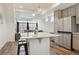Stylish kitchen with an island, stainless steel appliances, and open layout, flowing seamlessly into the living area at 4138 N Quatar Ct, Aurora, CO 80019