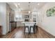 A modern kitchen featuring an island with seating, stainless steel appliances, and stylish finishes, creating an inviting space at 4138 N Quatar Ct, Aurora, CO 80019