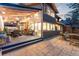Exterior view of backyard patio with outdoor dining area featuring an outdoor kitchen and sitting area at 2867 S Oswego Ct, Aurora, CO 80014