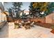 Backyard patio with outdoor furniture surrounding a fire pit and a hot tub in fenced in backyard at 2867 S Oswego Ct, Aurora, CO 80014