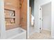 Bathroom with a tub and tiled shower with tiled inset shelf at 2867 S Oswego Ct, Aurora, CO 80014