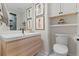 Bathroom featuring a modern vanity, framed art and a toilet at 2867 S Oswego Ct, Aurora, CO 80014
