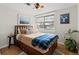 Cozy bedroom with hardwood floors, ceiling fan, and a large window at 2867 S Oswego Ct, Aurora, CO 80014