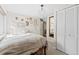 Bedroom featuring a closet, mirror, unique light fixture, and neutral color palette at 2867 S Oswego Ct, Aurora, CO 80014