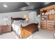 Comfortable bedroom featuring a custom wood bookcase with dresser and shelves at 2867 S Oswego Ct, Aurora, CO 80014