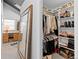 Walk-in closet with lots of shelves for shoes and folded cloths with hanging rods for clothes at 2867 S Oswego Ct, Aurora, CO 80014