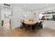 Bright dining area with a wooden table, cushioned bench seating, and hardwood floors at 2867 S Oswego Ct, Aurora, CO 80014