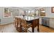 Bright kitchen with large island, marble countertop, wooden legs, and seating beneath bright windows at 2867 S Oswego Ct, Aurora, CO 80014