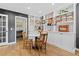 Living room with hardwood floors, built-in shelves, a table, and a view into the bathroom at 2867 S Oswego Ct, Aurora, CO 80014