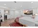 Large basement bedroom with a wet bar, tv, and ensuite bathroom with walk-in closet at 2867 S Oswego Ct, Aurora, CO 80014