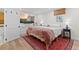 Bright basement bedroom features a woven blind, flatscreen TV, and colorful accent rug at 2867 S Oswego Ct, Aurora, CO 80014