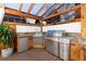 Outdoor kitchen and bar area with stainless steel grill, mini fridge, and sink for outdoor entertainment at 2867 S Oswego Ct, Aurora, CO 80014