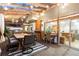 Covered outdoor patio with dining table set, grill, bar with sink, and an entry way to home's living area at 2867 S Oswego Ct, Aurora, CO 80014