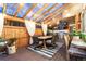 Outdoor covered patio area featuring a dining table set, grill, bar with sink, and overhead string lights at 2867 S Oswego Ct, Aurora, CO 80014